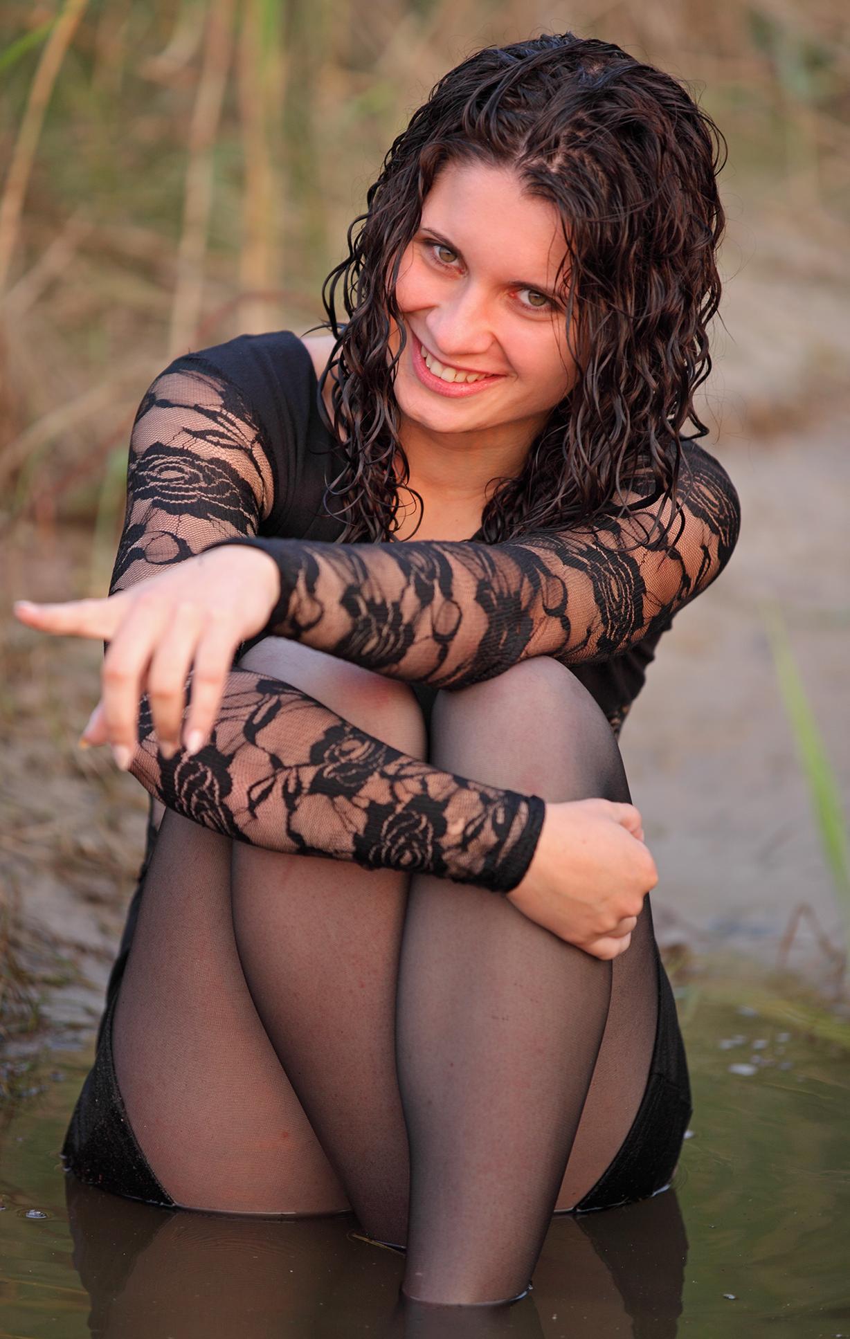 Brunette Young Woman wearing Wet Black Pantyhose and Black Lace Top
